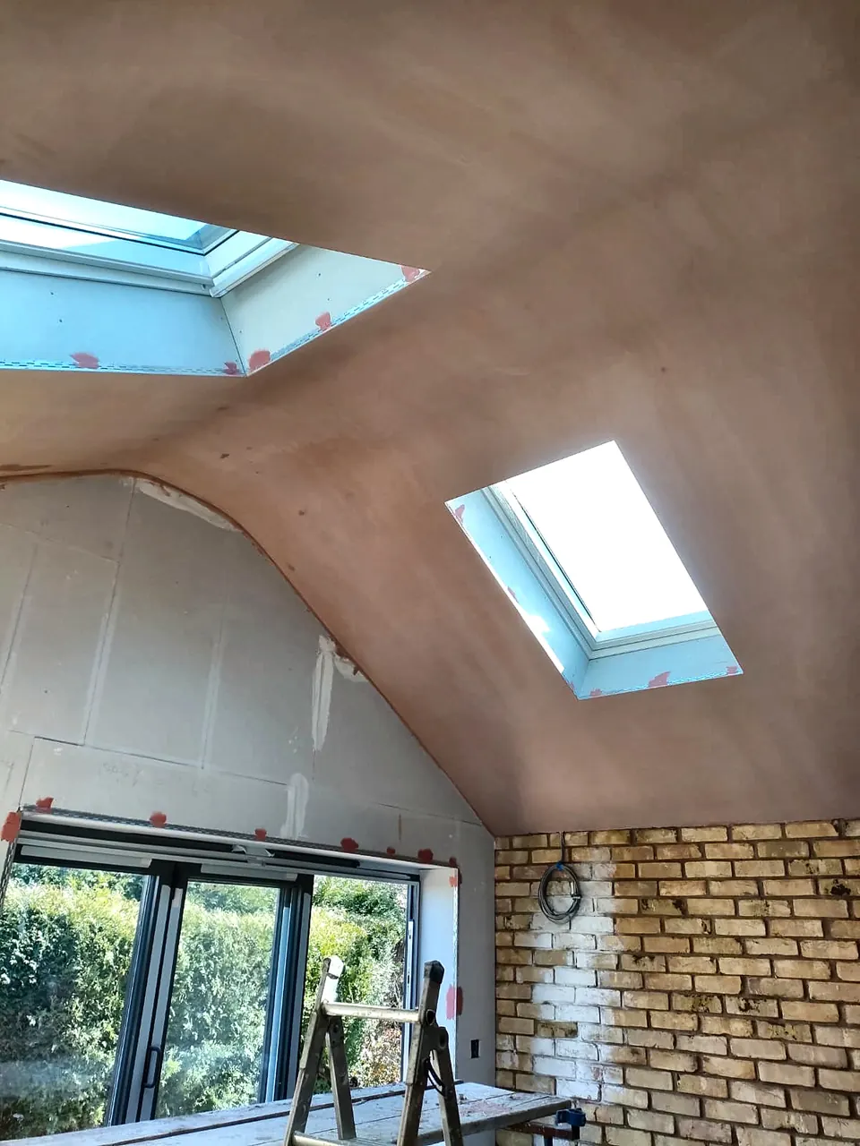 Sloping plastered ceiling with two roof windows