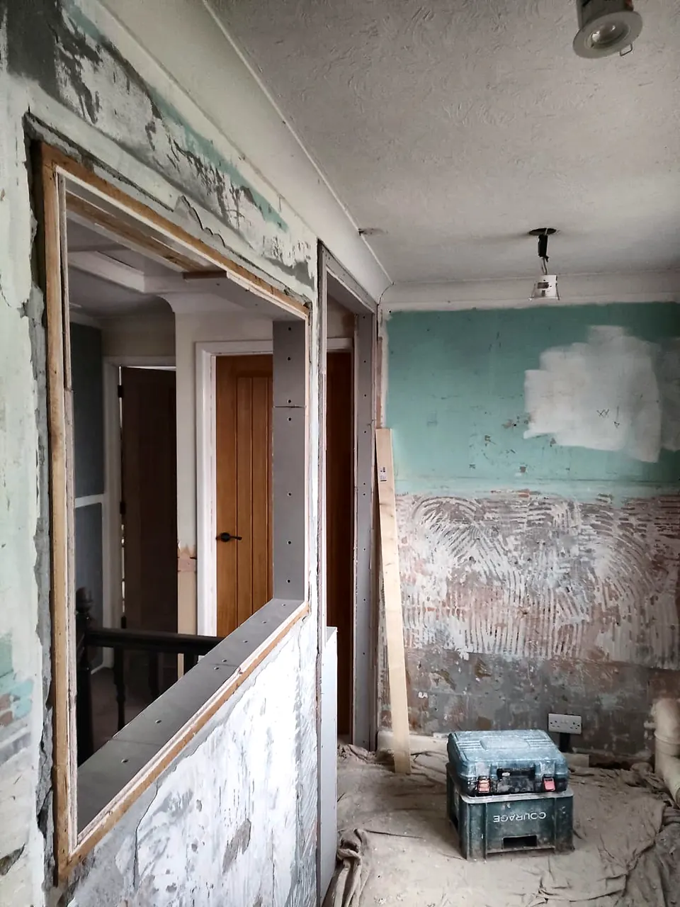 Interior wall stripped back before plastering during renovation
